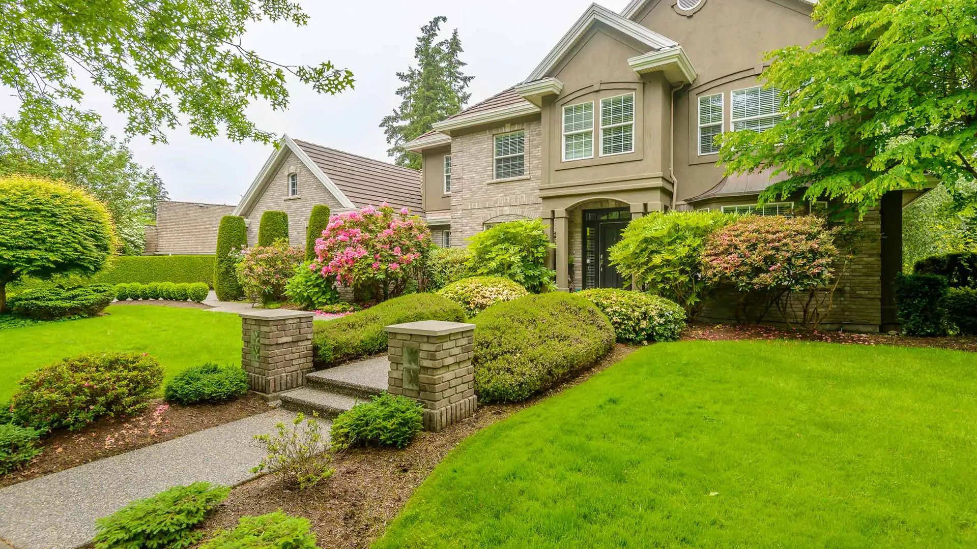 A house with walkway and lush lawn in Wayne, PA.
