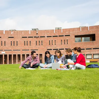 students on a college campus lawn